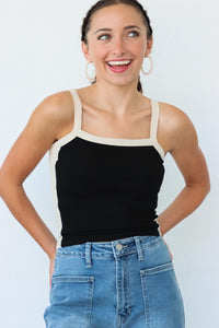 girl wearing black tank top with white contrast fabric detailing