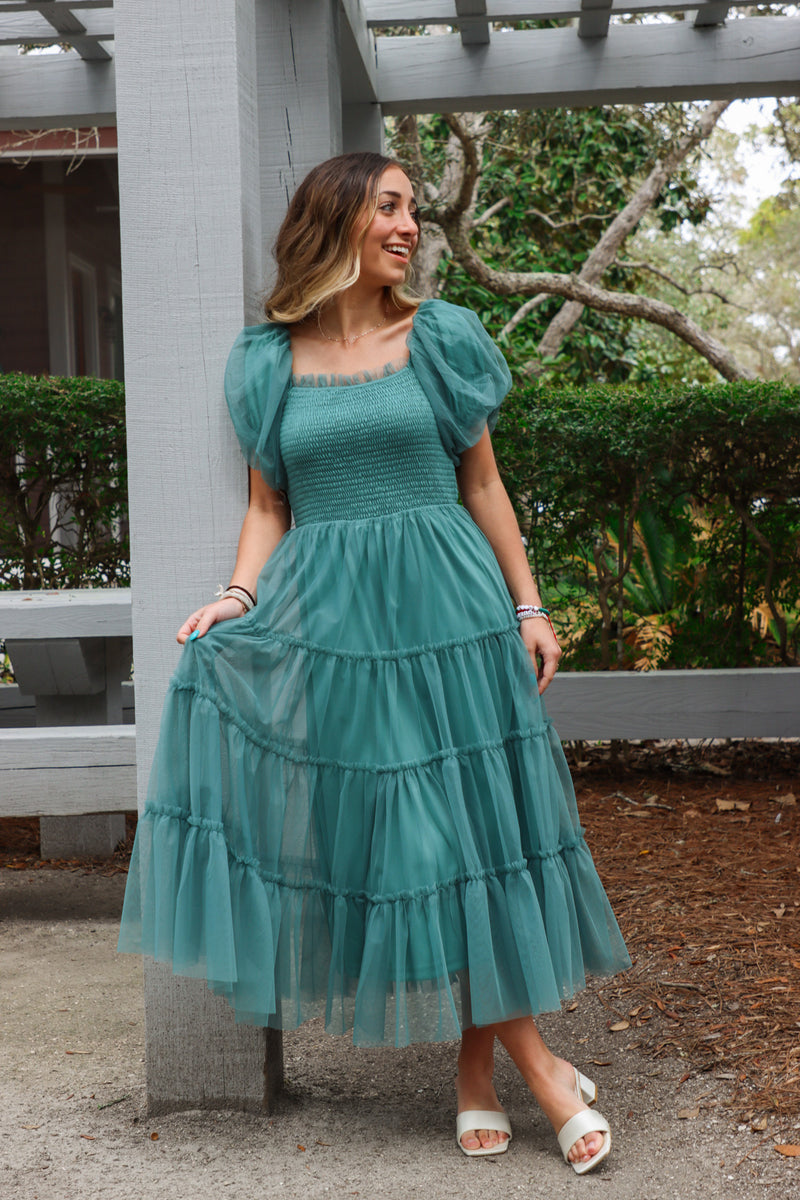 girl wearing green long dress with tulle detailing