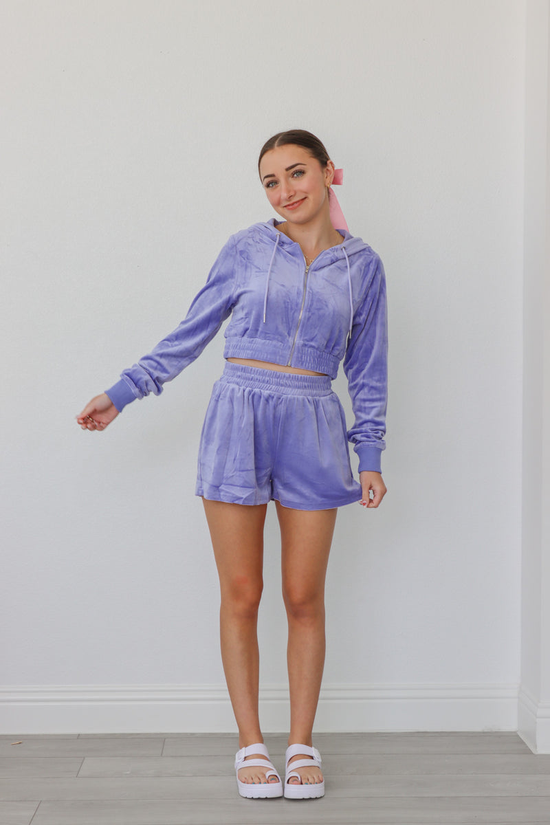 girl wearing lilac velour tracksuit