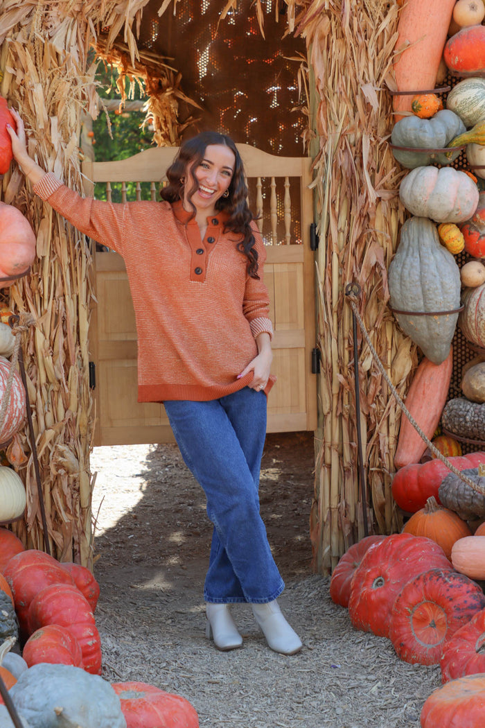 girl wearing orange long sleeved sweater