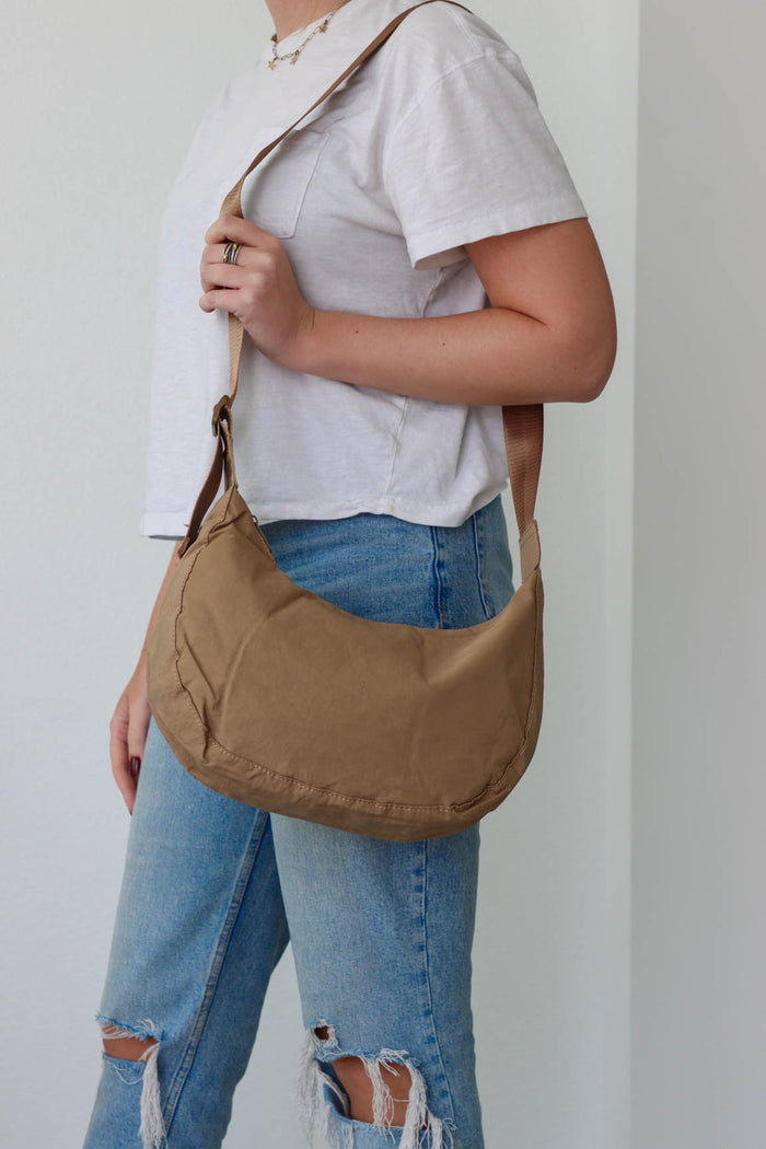 girl carrying tan nylon bag