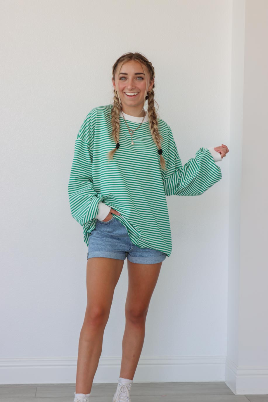 girl wearing green striped oversized long sleeve shirt