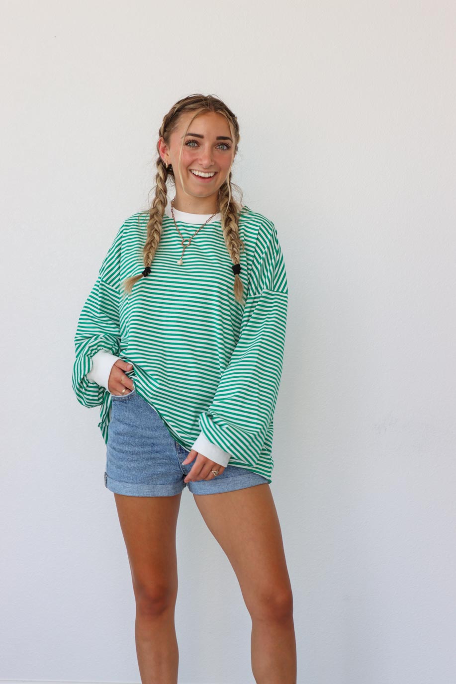 girl wearing green striped oversized long sleeve shirt