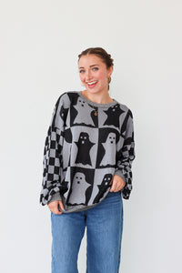 girl wearing gray and dark gray checker print ghost sweater