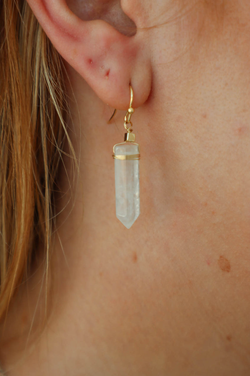 girl wearing white geod earrings