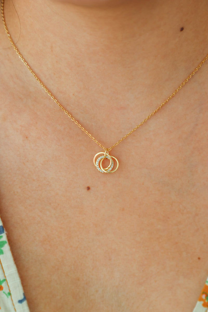 gold necklace with intertwined circle pendant