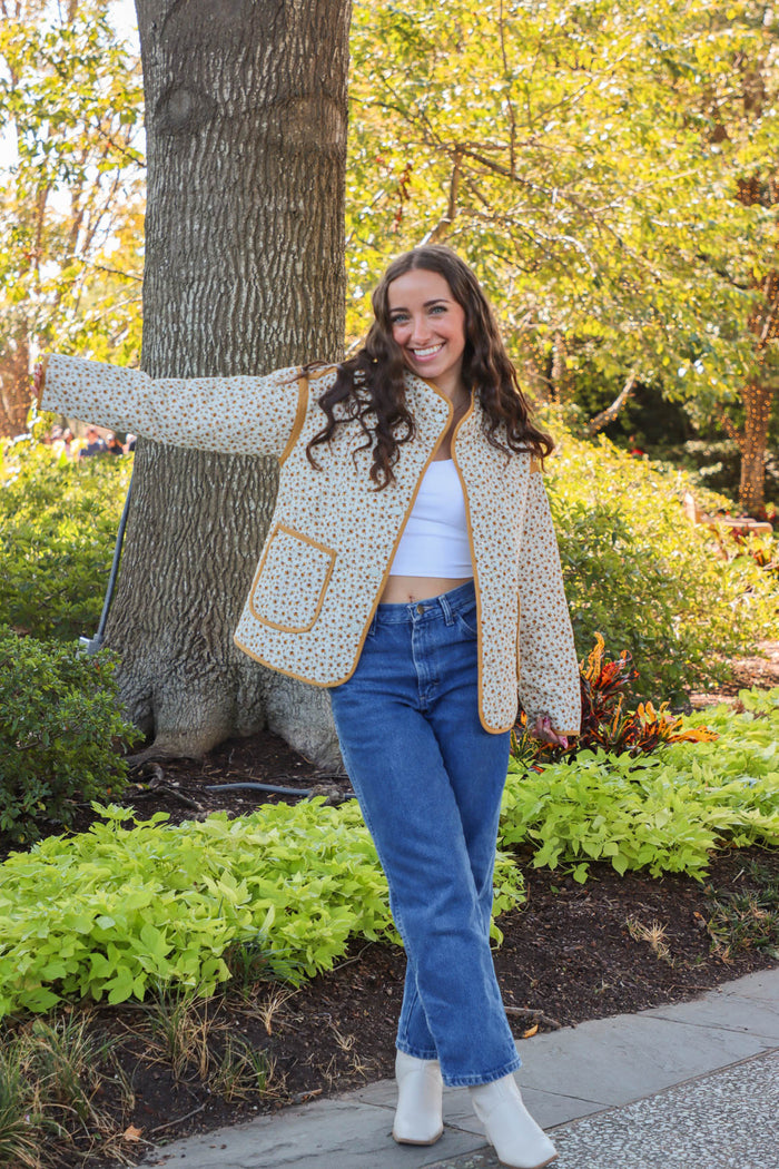 girl wearing cream quilted jacket