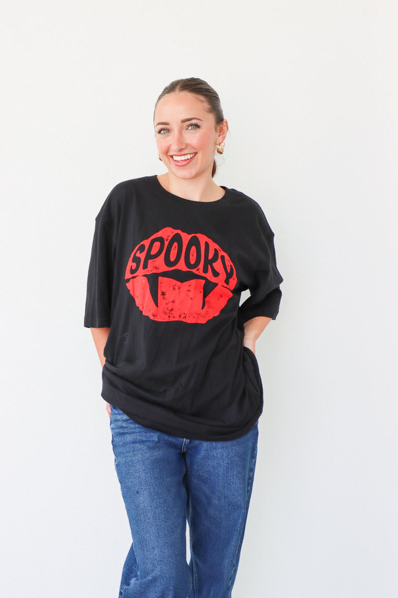 girl wearing "spooky" black graphic tee