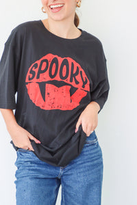 Person wearing a black oversized t-shirt with red 'Spooky' graphic design on a white background