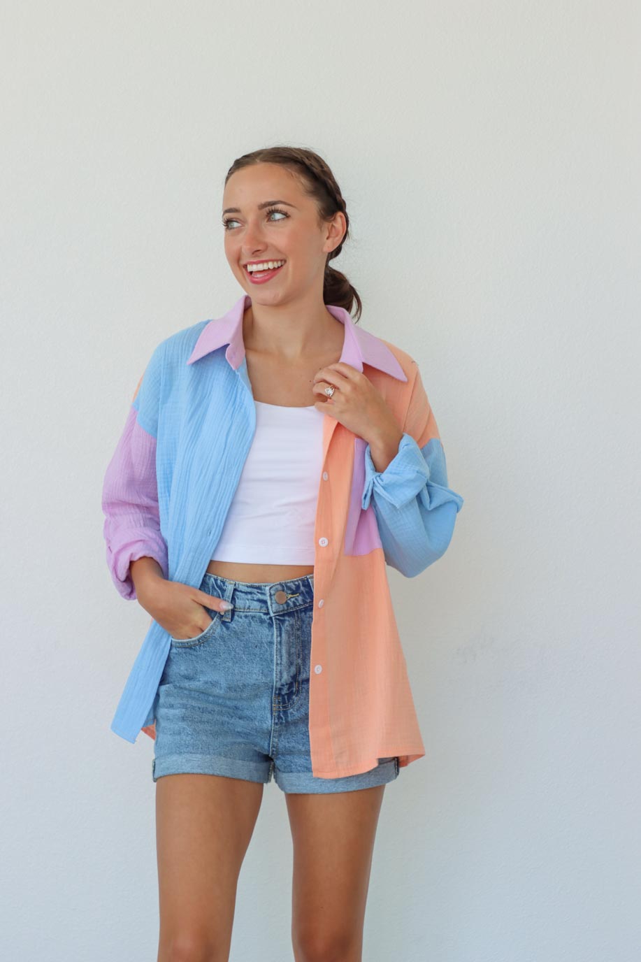 girl wearing pastel multicolored button down top
