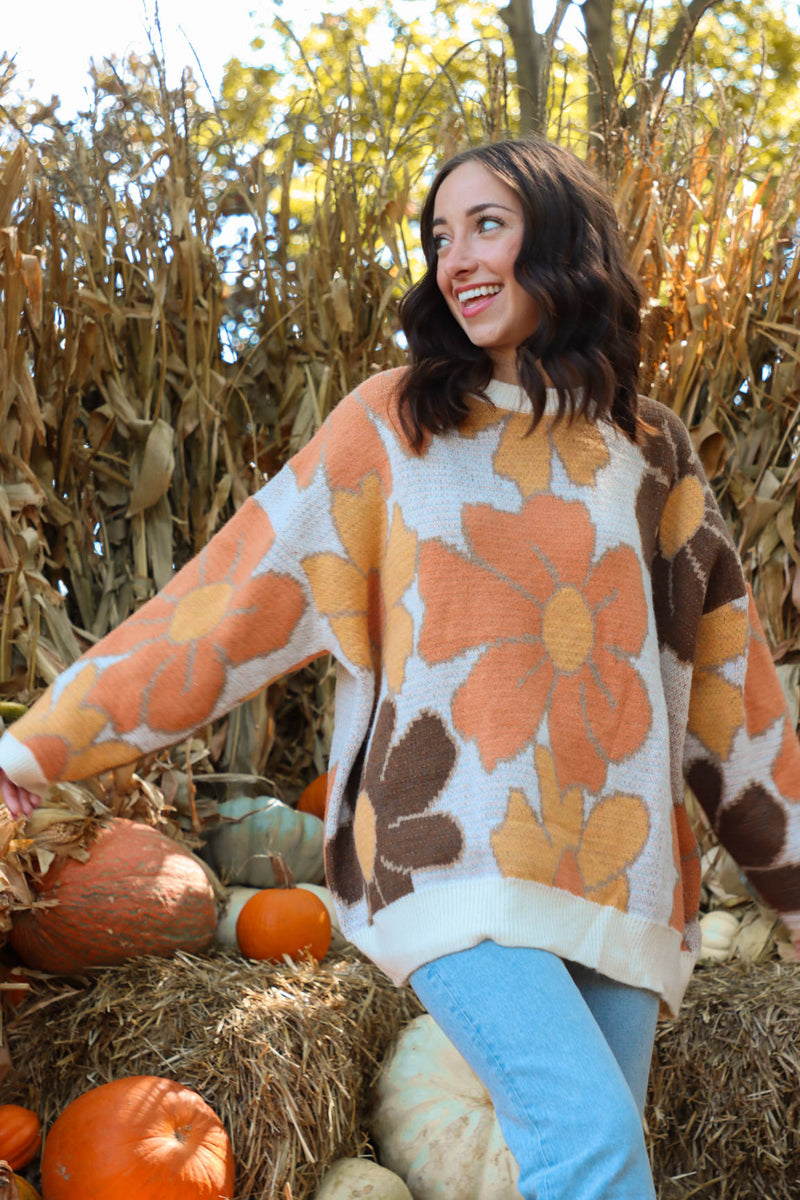 girl wearing brown and orange floral sweater