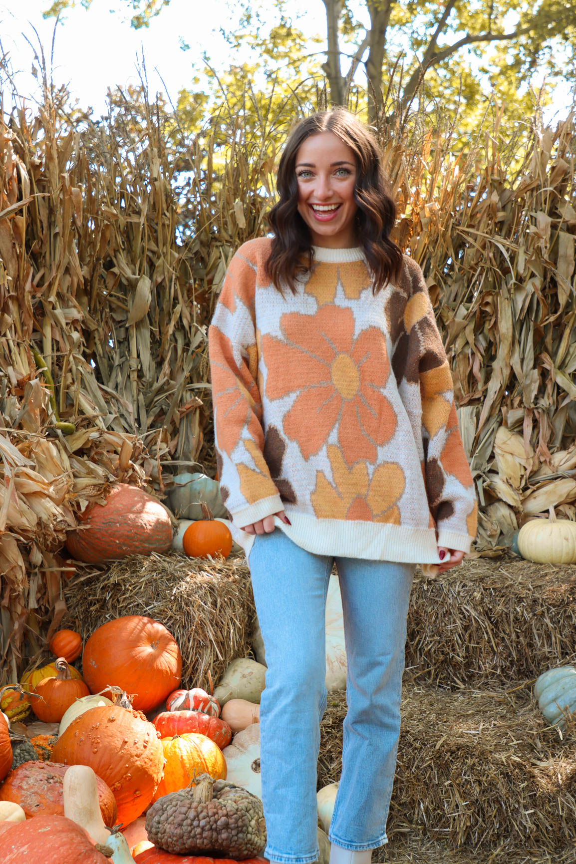 girl wearing brown and orange floral sweater