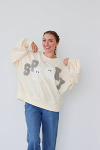 girl wearing cream "spooky" longsleeve top