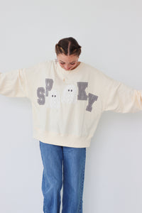 girl wearing cream "spooky" longsleeve top