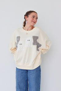 girl wearing cream "spooky" longsleeve top