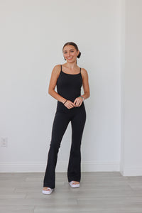 girl wearing black flare leg athletic jumpsuit