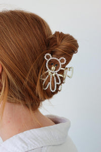 girl wearing gold teddy bear rhinestone claw clip in her hair