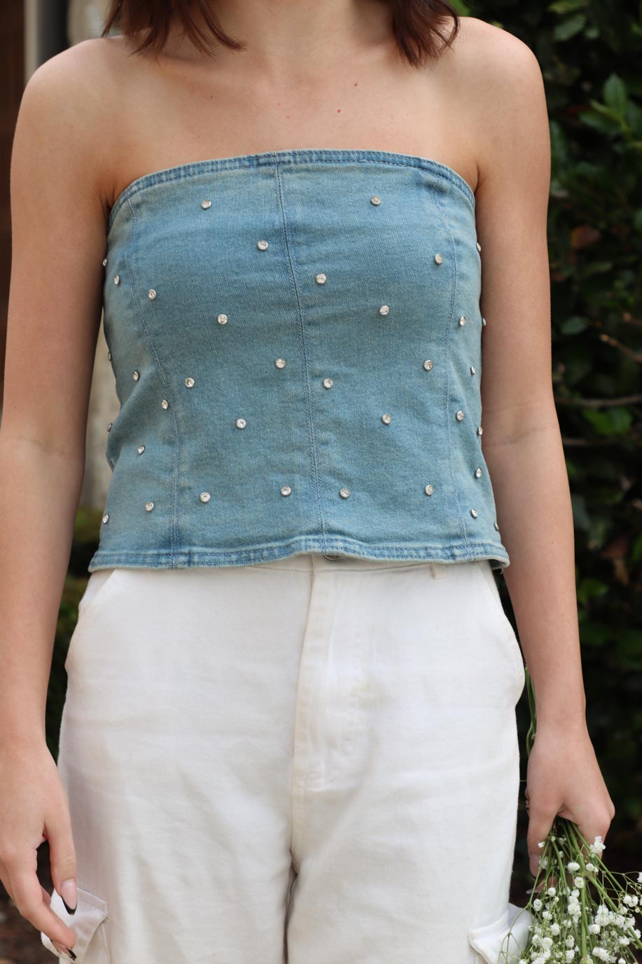 girl wearing strapless denim top with rhinestone detailing