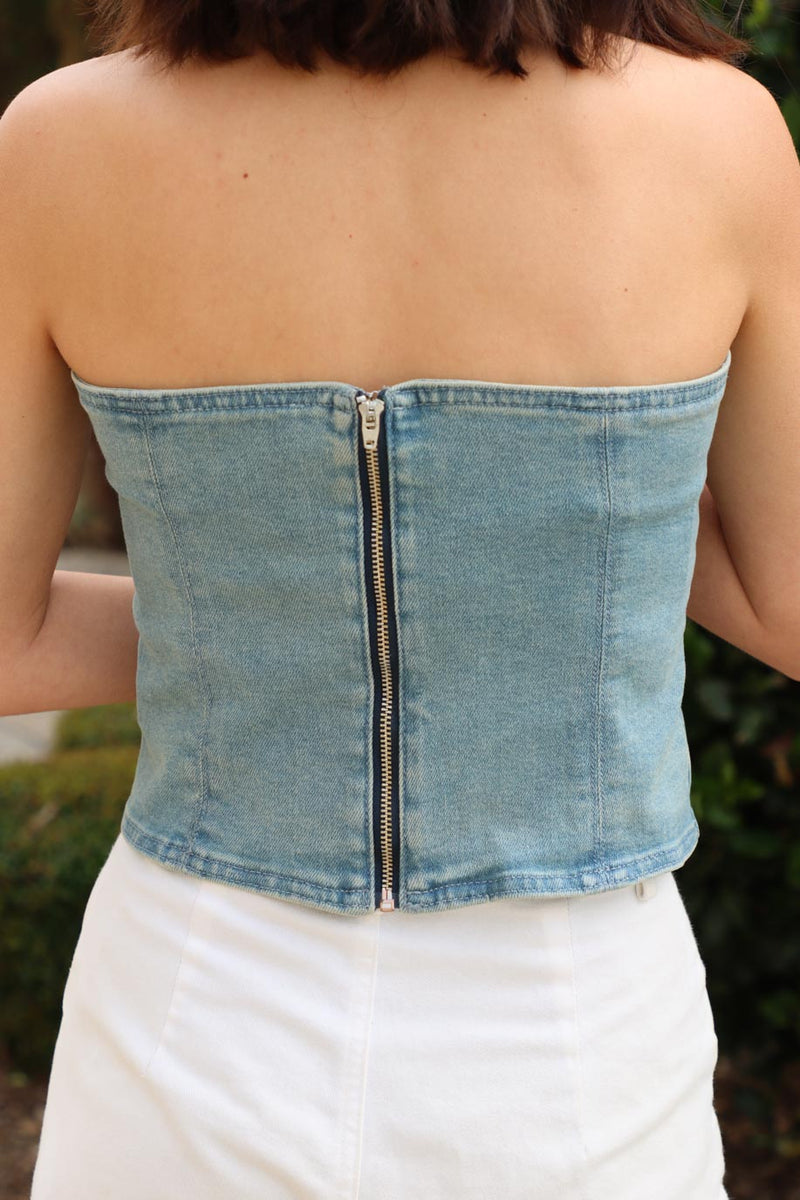 girl wearing strapless denim top with rhinestone detailing