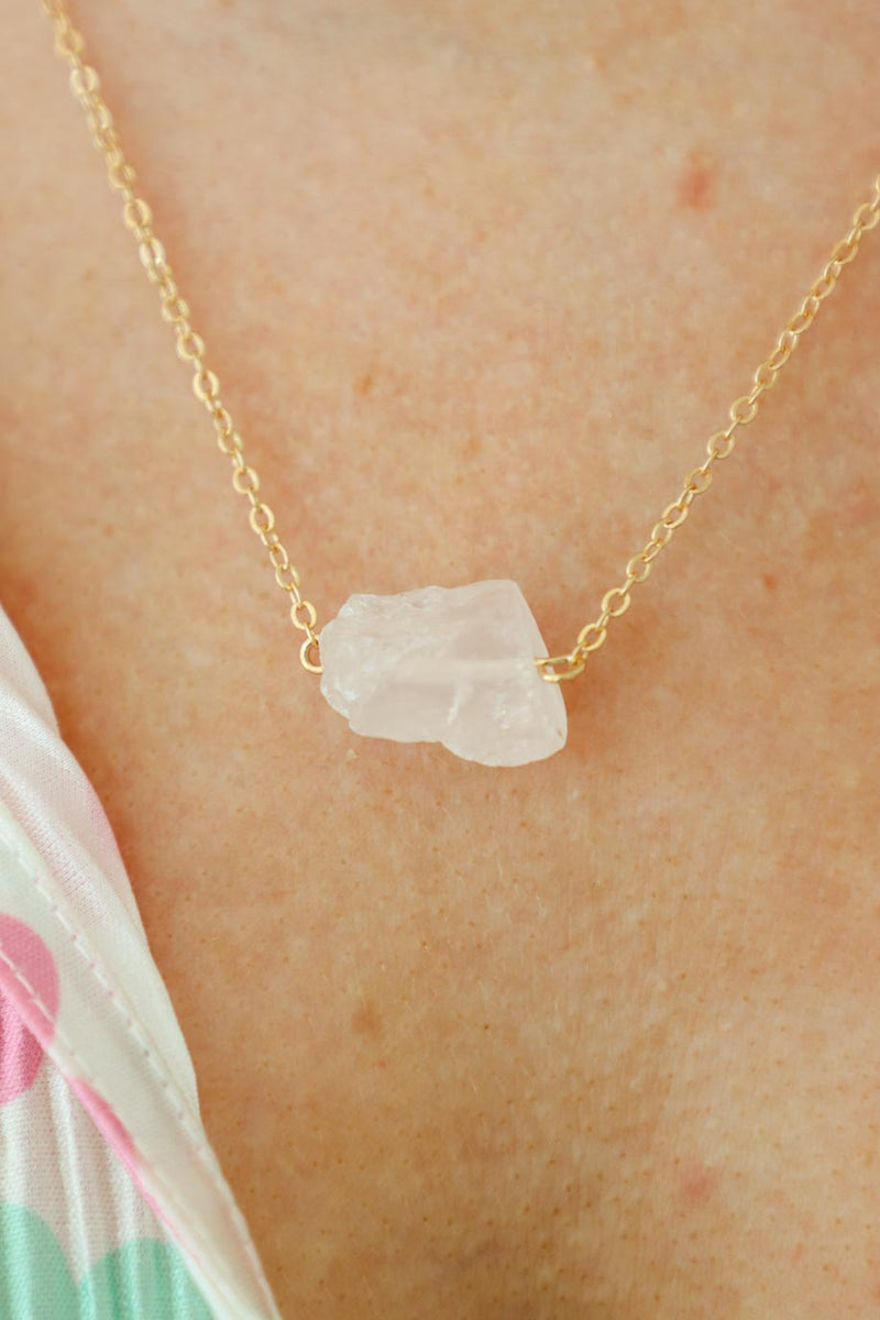 girl wearing white stone necklace