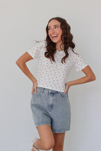 girl wearing white baby tee with cherry pattern