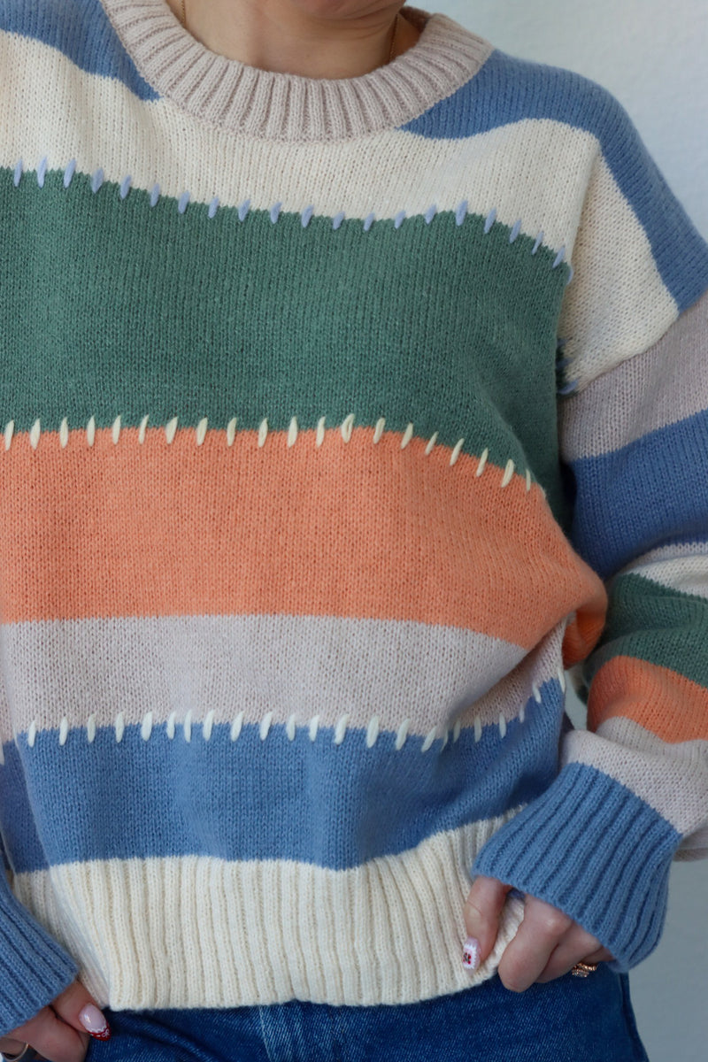 girl wearing multicolor knit sweater