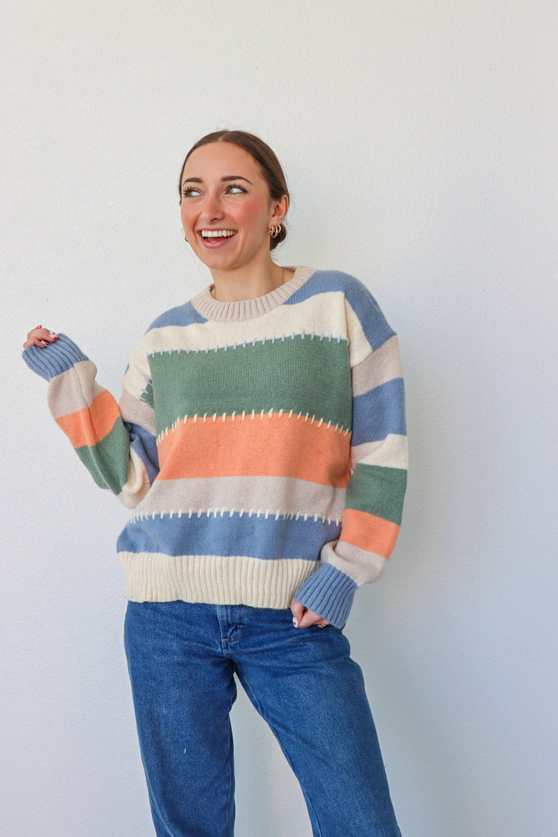 girl wearing multicolor knit sweater