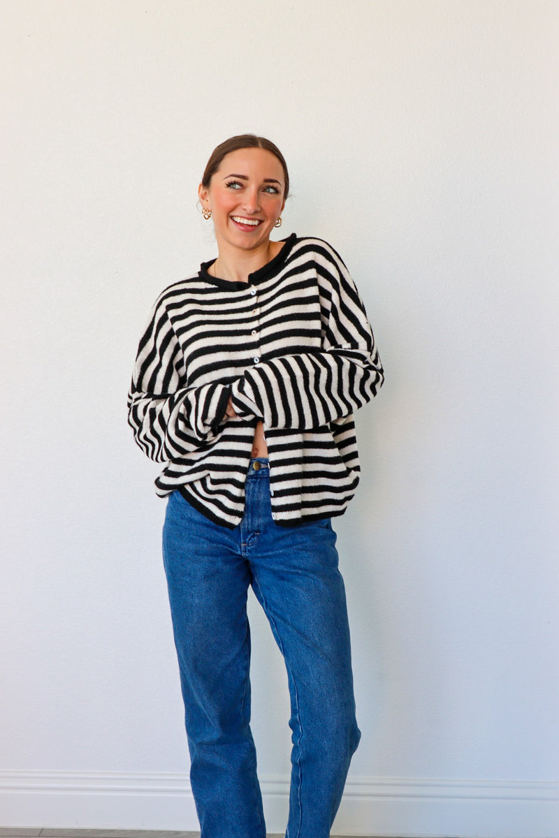 girl wearing black and white striped cardigan