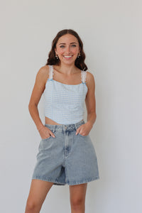 girl wearing blue gingham cropped top with lace sleeves