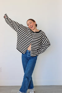 girl wearing black and white striped cardigan