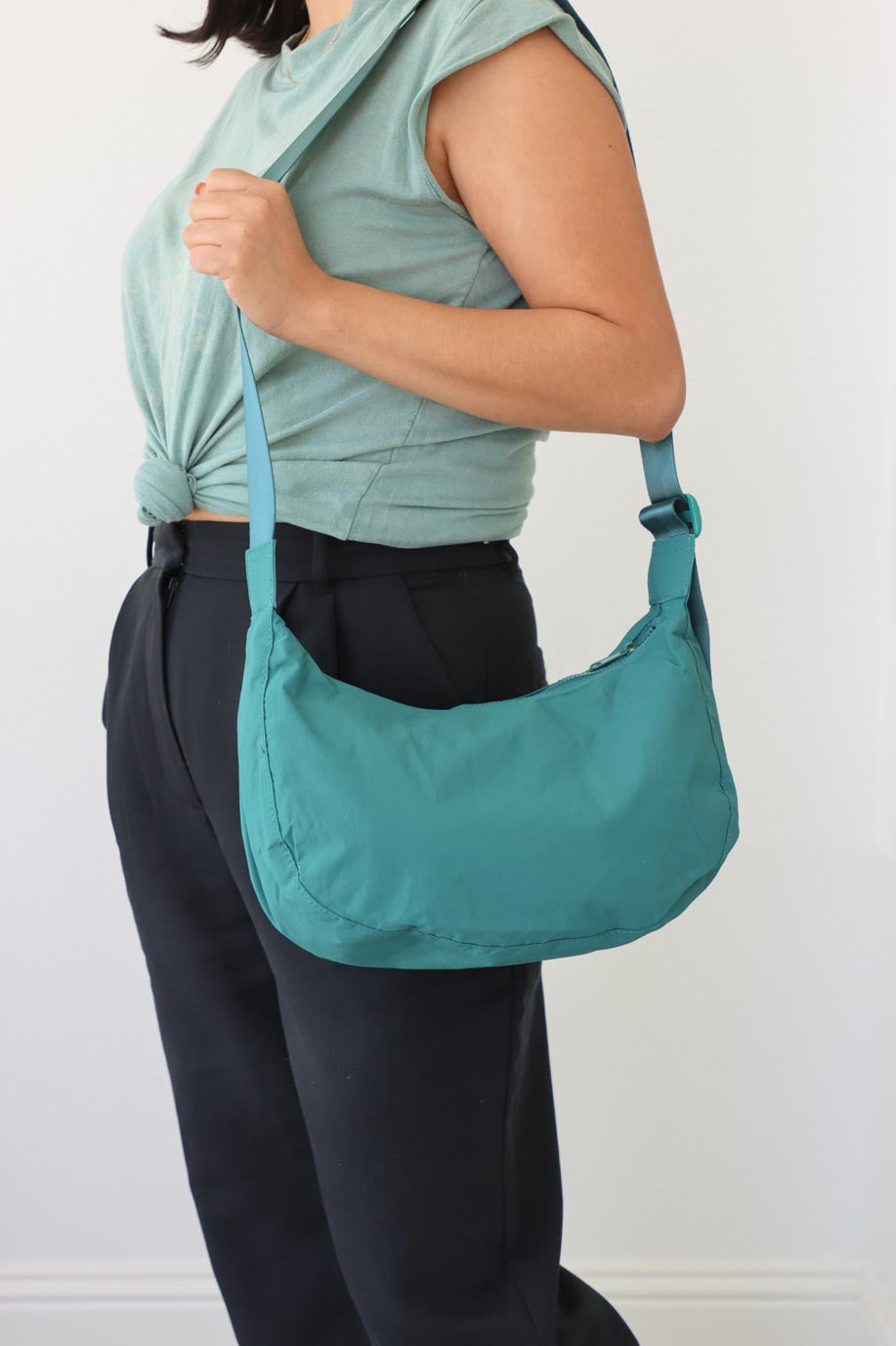 girl carrying teal nylon bag