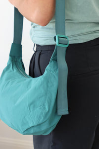 girl carrying teal nylon bag