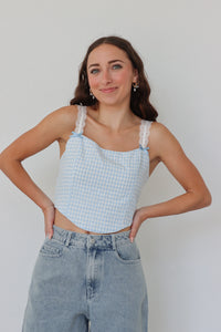 girl wearing blue gingham cropped top with lace sleeves