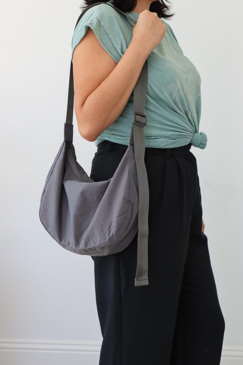 girl carrying gray nylon bag