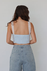 girl wearing blue gingham cropped top with lace sleeves