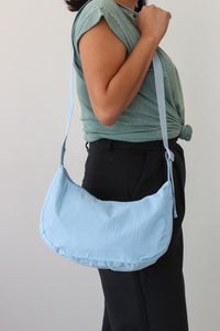girl carrying blue nylon bag