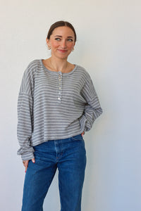 girl wearing gray and white striped top