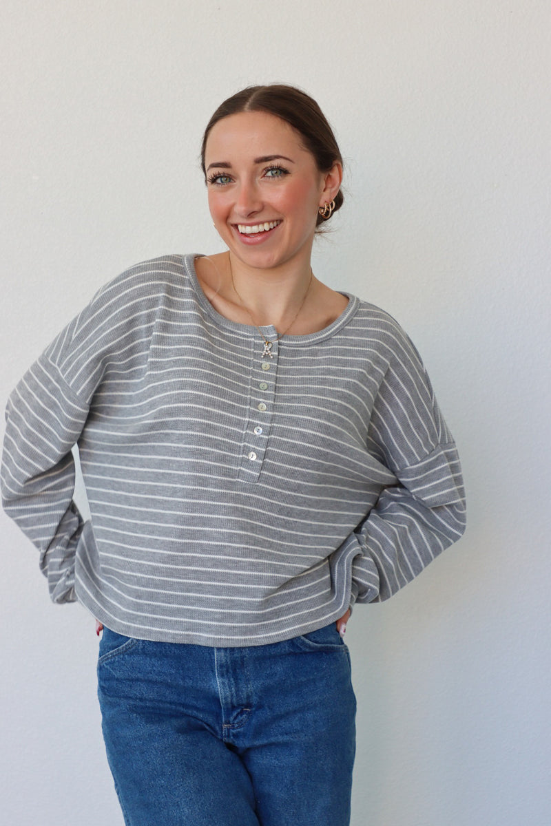 girl wearing gray and white striped top