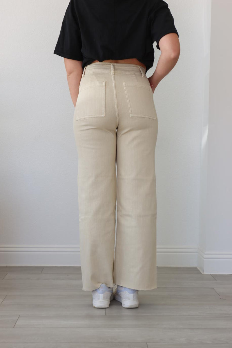 girl wearing cream denim pants