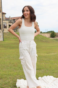 girl wearing white ruffle tank top bodysuit