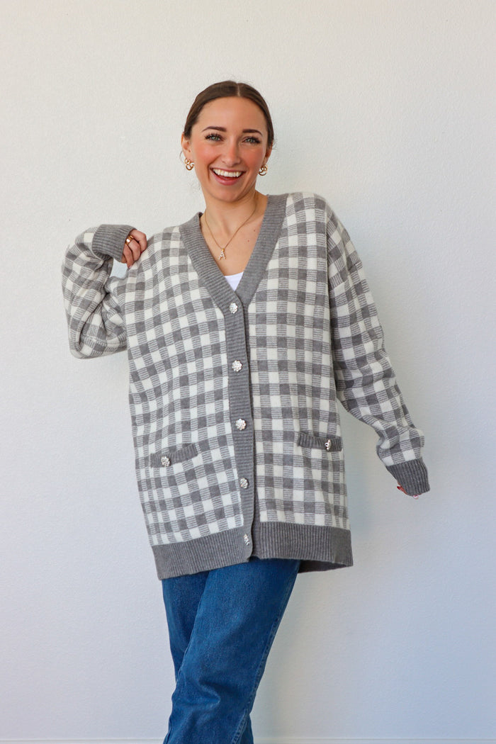 girl wearing gray houndstooth cardigan