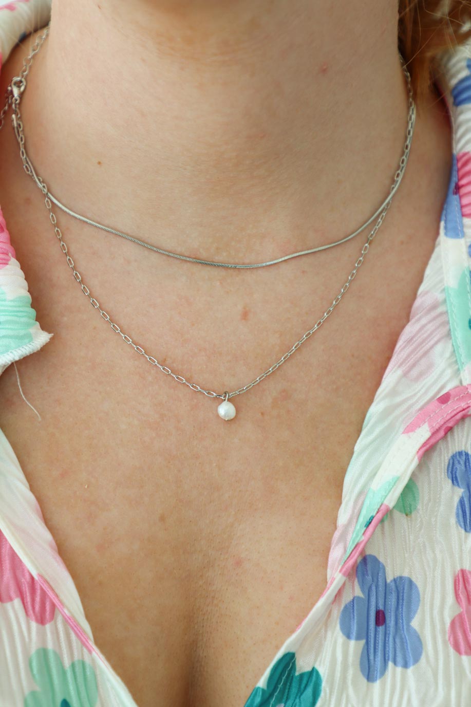 girl wearing silver chain necklace with pearl charm