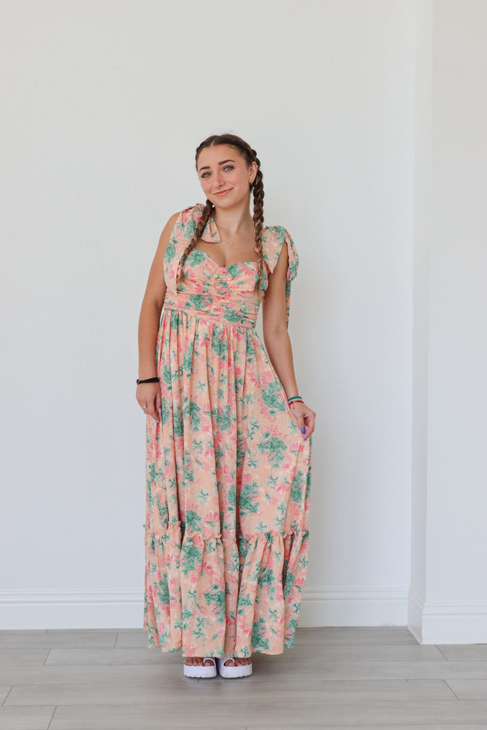 girl wearing peach long dress with palm pattern