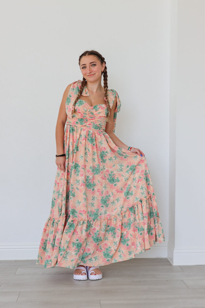 girl wearing peach long dress with palm pattern