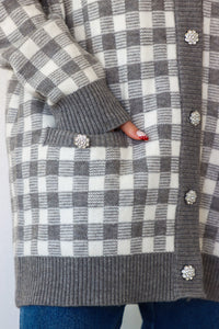 girl wearing gray houndstooth cardigan