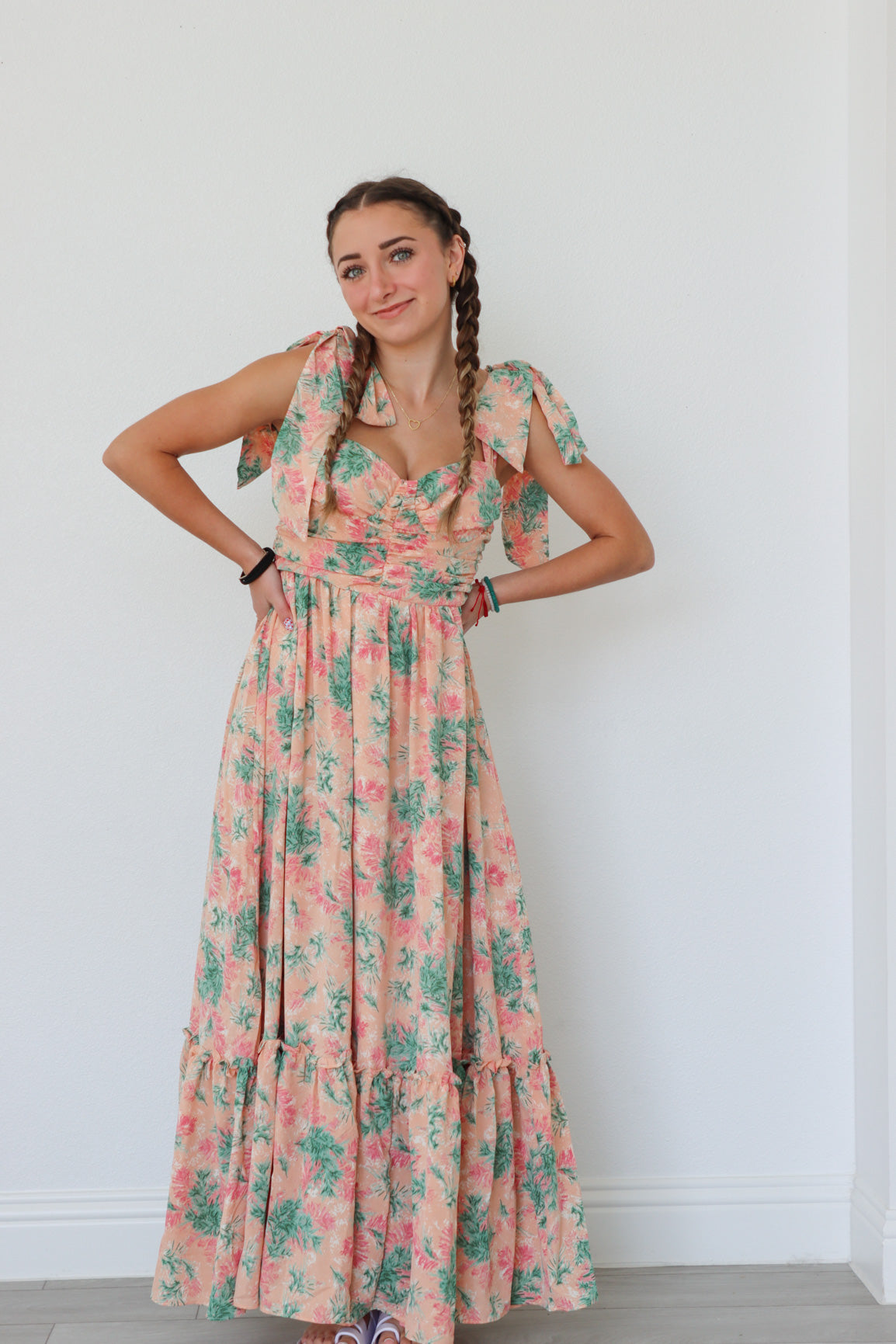 girl wearing peach long dress with palm pattern