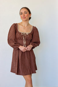 girl wearing brown peasant style dress