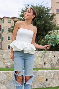 girl wearing strapless white peplum top