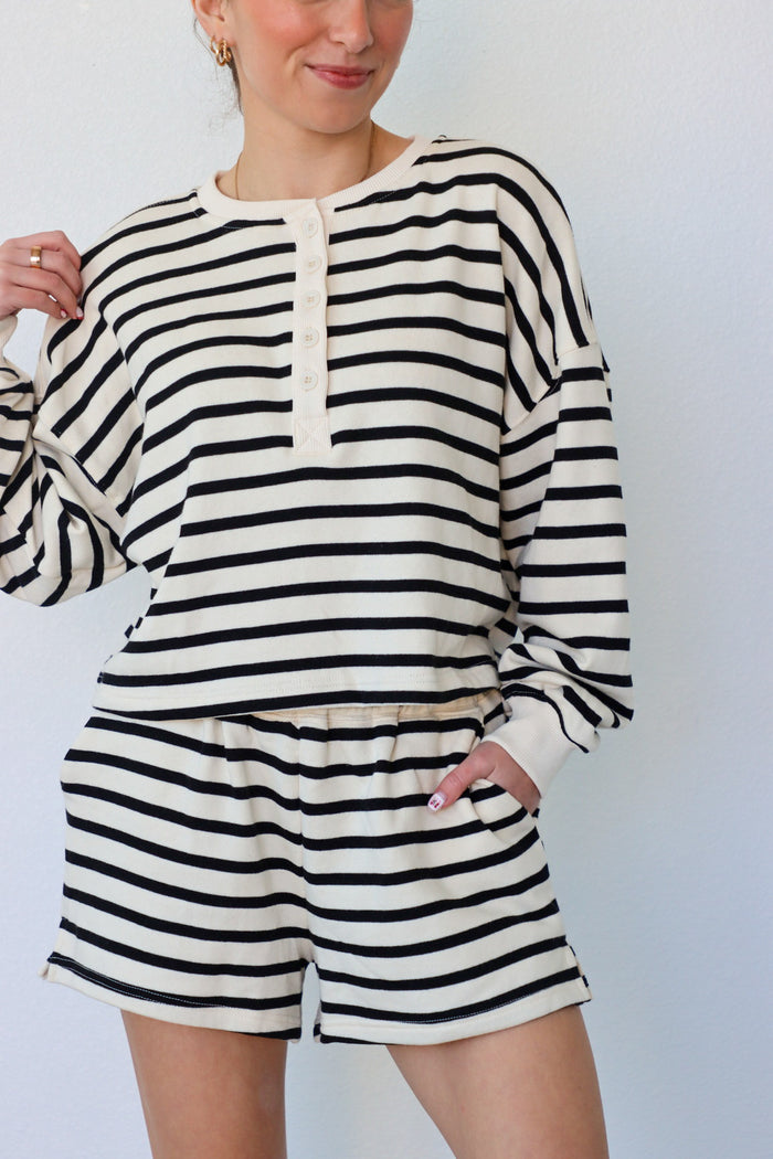 girl wearing black and cream striped set