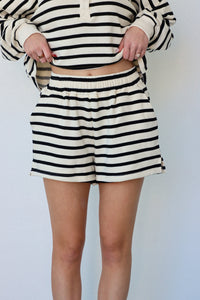 girl wearing black and cream striped set